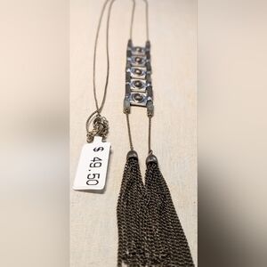 A tall Macy's necklace in brass and silver hues. Tassels add drama.NWT.